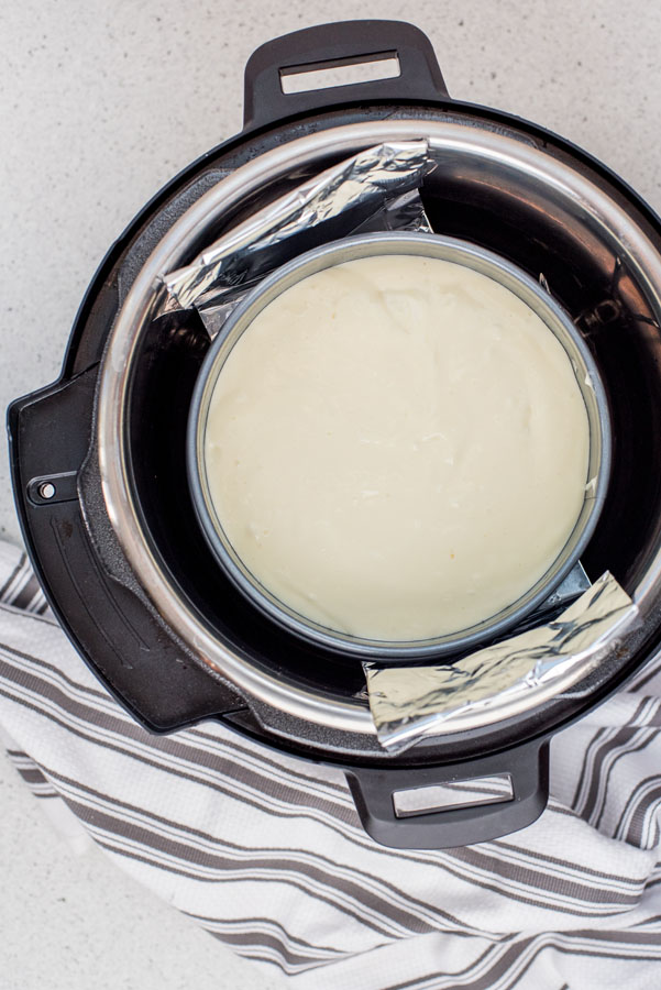 Cheesecake cooked inside an Instant Pot with a foil sling.
