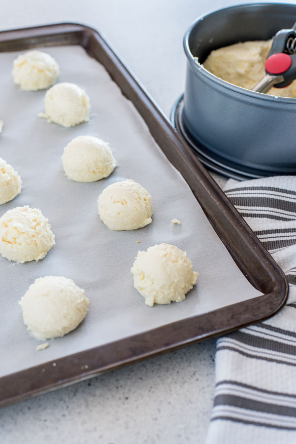 How to scoop out cheesecake bites and place them on a baking sheet to freeze.