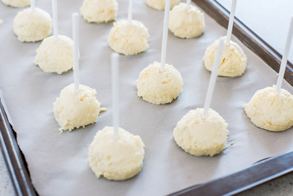 How to make cheesecake bites by freezing the pops prior to dipping.