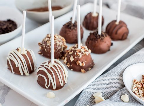 Pressure Cooker cheesecake bites / pops made in an Instant Pot and decorated with various toppings on a platter.