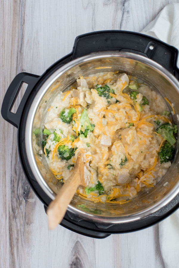 Stirring in the cheese for the cheesy chicken and broccoli casserole made in an Instant Pot.