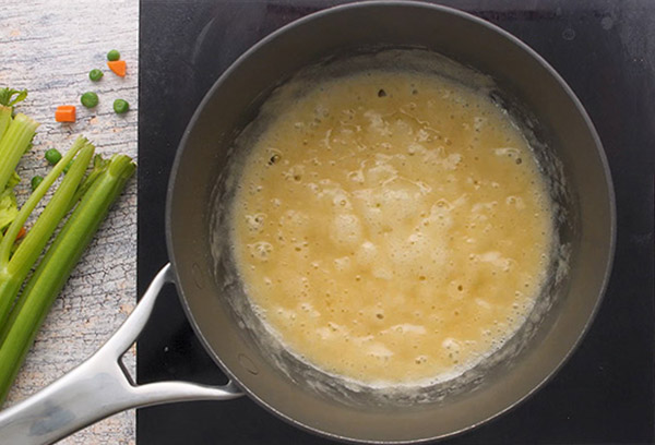 Overhead of a black skillet with cooked butter and flour mixture to thicken 