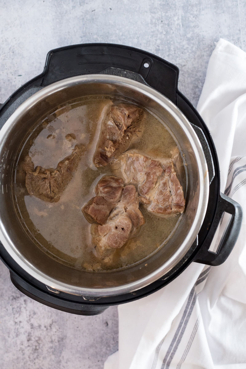 instant pot with pork butt cooking for chili verde