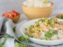 Close up of Instant Pot creamy chipotle chicken served over white rice and garnished with fresh cilantro and served in a white bowl.