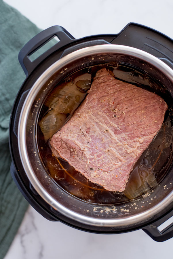 Overhead of brisket before it’s cooked inside an Instant Pot for corned beef and cabbage.