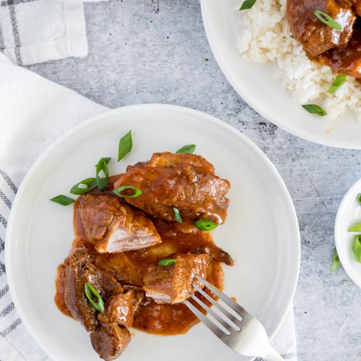 white plate with country style pork ribs in gravy