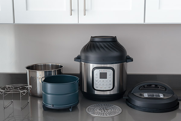 Instant Pot Duo Crisp with air fryer lid and accessories that include, trivet and dual layer air fryer basket.