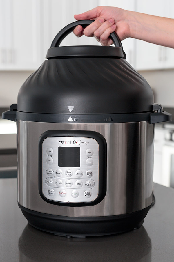 Instant Pot Duo Crisp from the front placing the air fryer lid.
