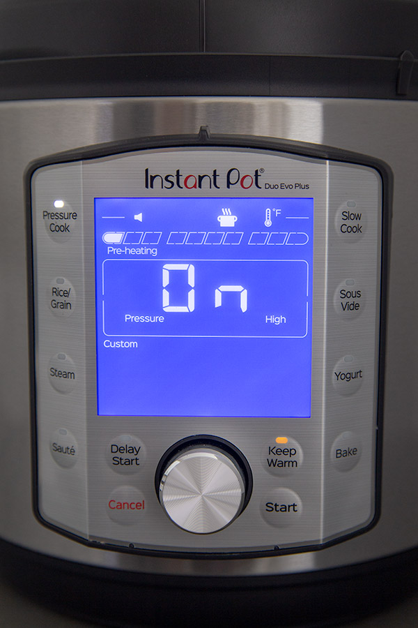 Close up shot of the Instant Pot Duo Evo Plus control panel in preheating mode