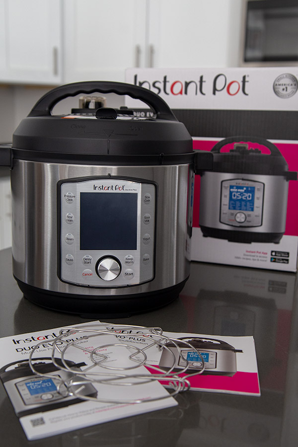 Instant Pot Evo pressure cooker with user guide and trivet