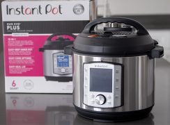 Instant Pot Duo Evo Plus sitting on a gray countertop with the InstaPot Evo packaging in the background.