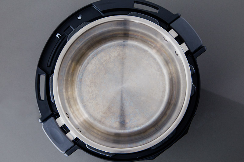 An overhead view of the Instapot Evo Plus inner cooking pot with handles viiable inside the housing