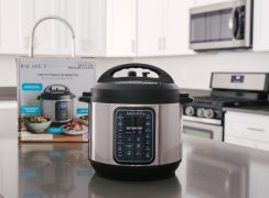 direct front shot of the Instant Pot Duo Gourmet on a gray countertop with the box and white cabinets in the background