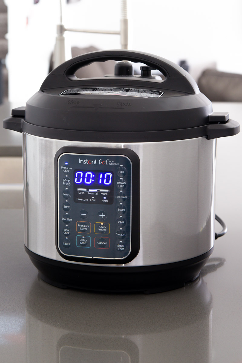 direct front shot of the Instant Pot Duo Gourmet with the Pressure Cook button selected and 10 minutes on the timer