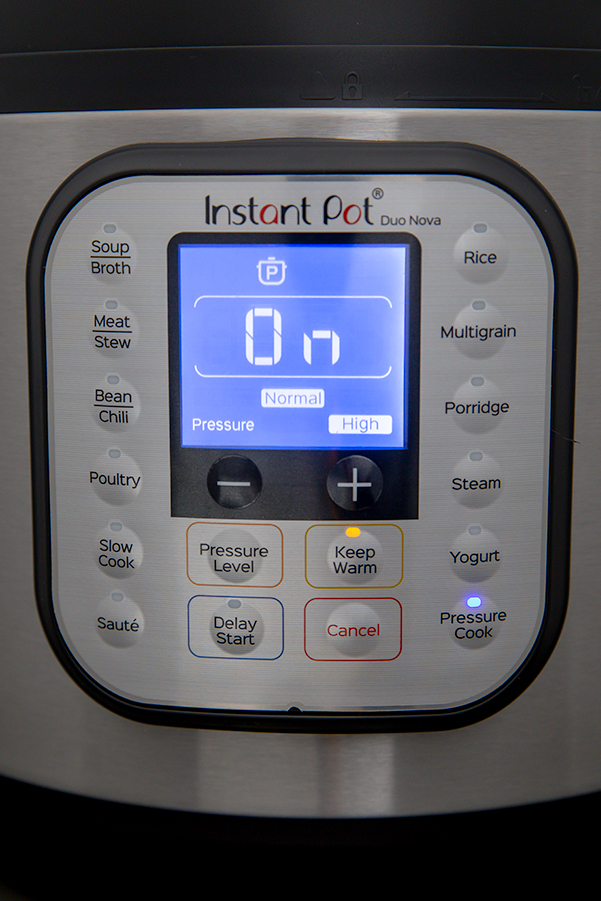 Instant Pot Duo Nova control pannel display with preset buttons and manual pressure cooker options.