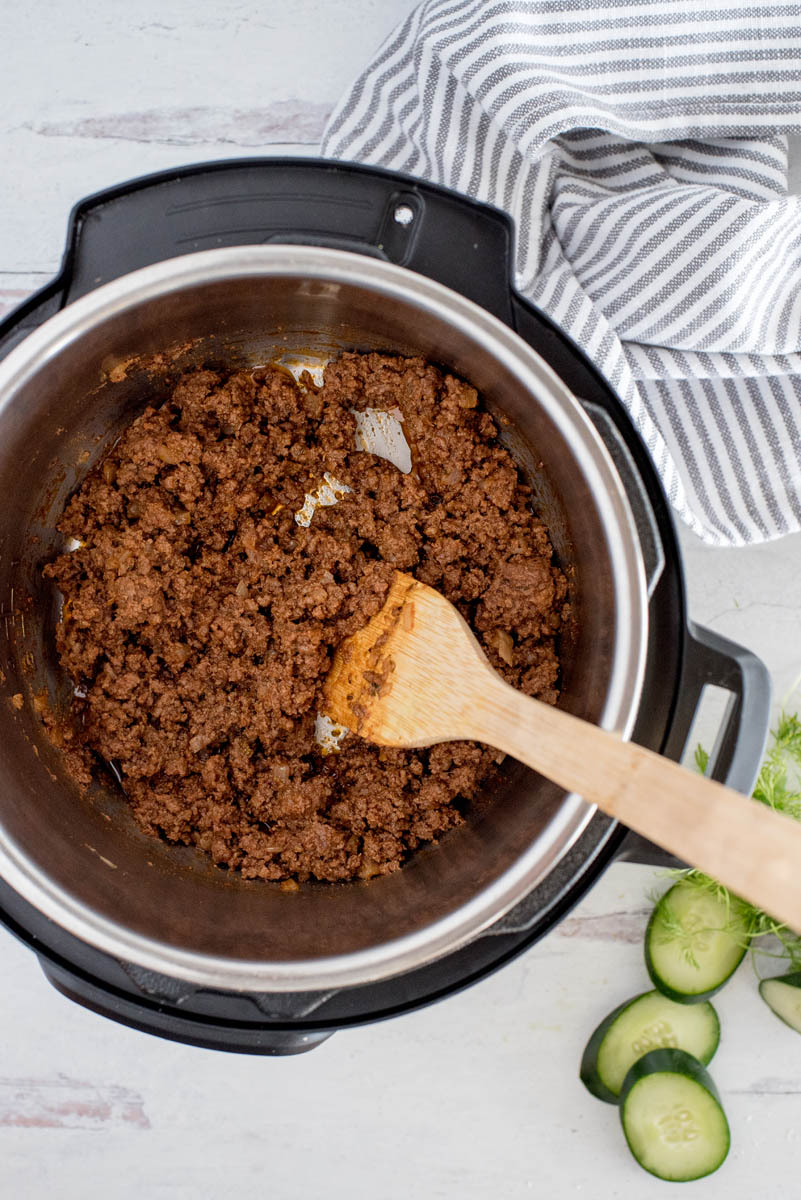 overhead of an instant pot with greek beef taco filling
