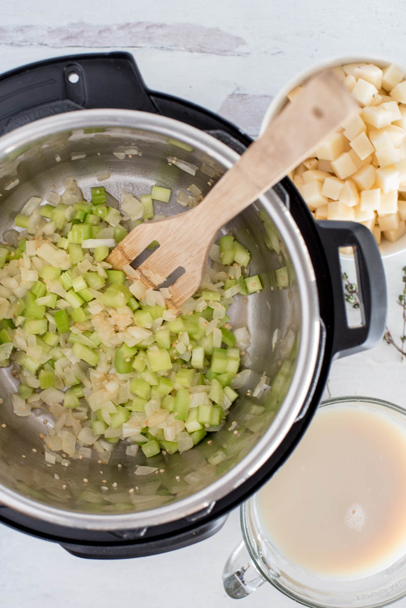 Sauteing onions and celery for clam chowder cooked in an Instant Pot.
