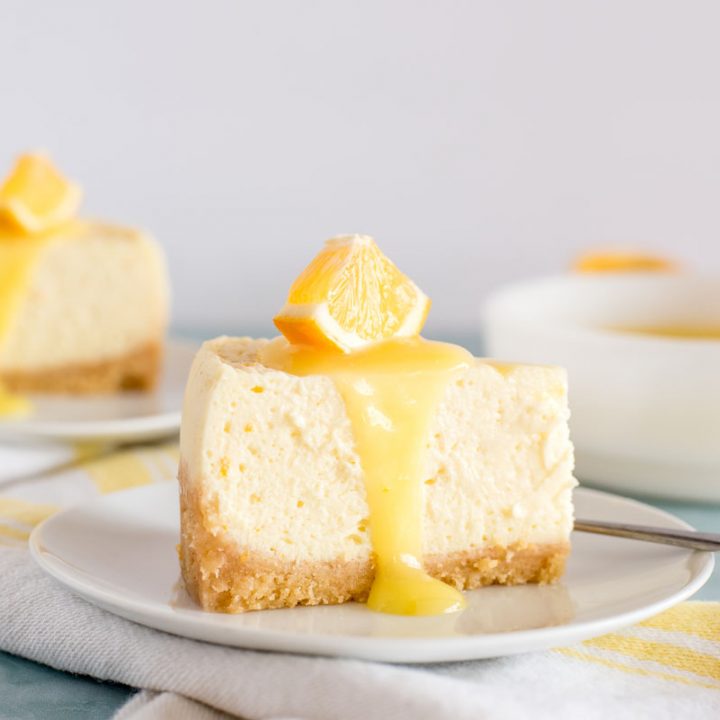 slices of instant pot lemon cheesecake with lemon curd on top