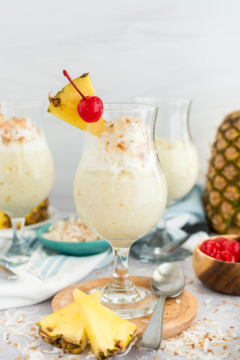 two glasses of coconut rice pudding with fresh pineapple