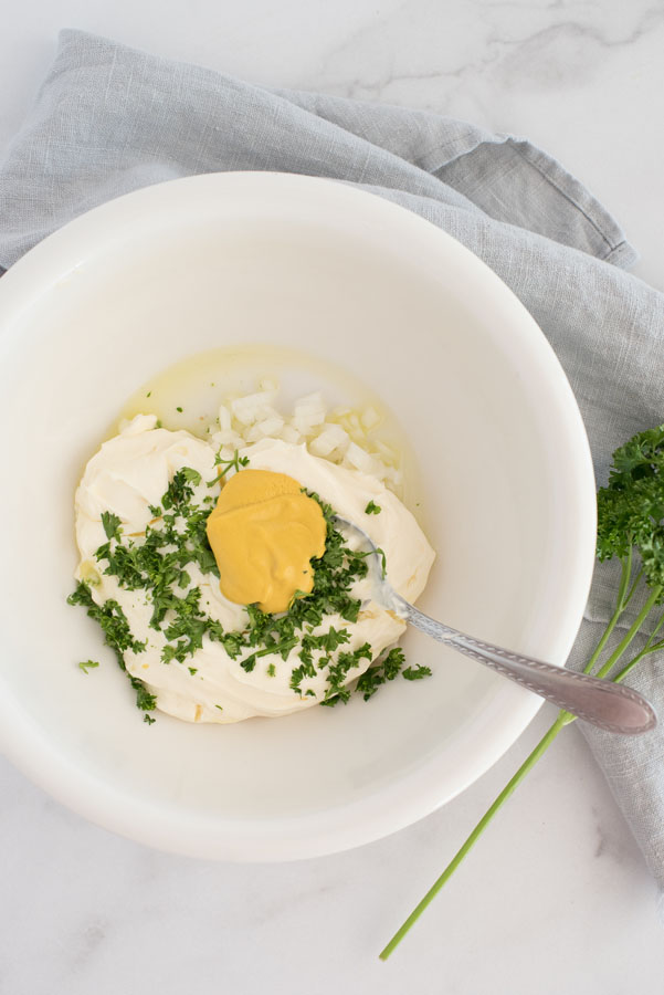 ingredients for quick pressure cooker potato salad: mayonnaise, dijon mustard, fresh herbs