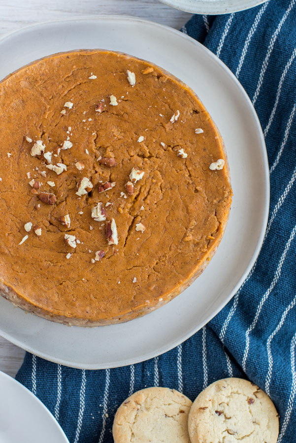 Insta pot pumpkin pie overhead view with chopped pecans on top.