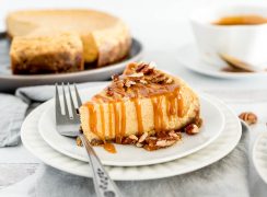 slice of pumpkin cheesecake drizzled with caramel sauce