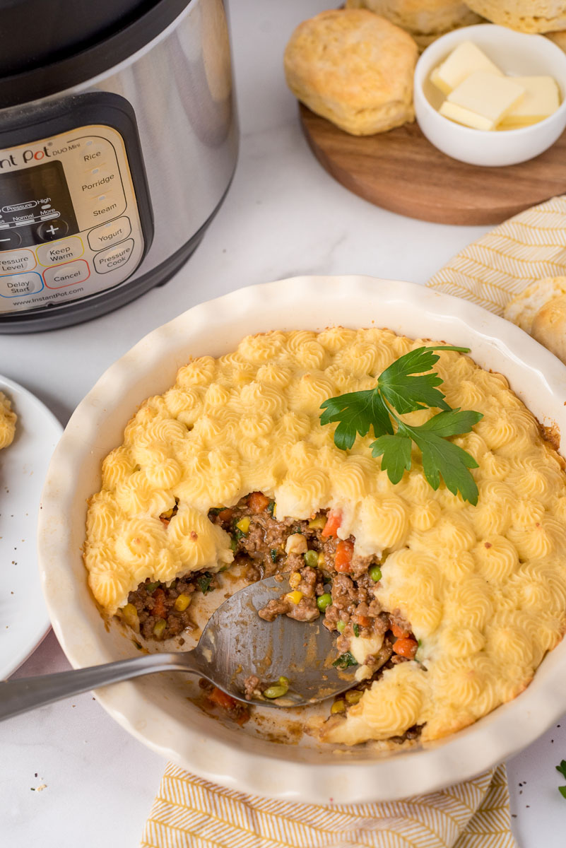 Shepherds Pie dished out and placed in front of an Instant Pot.