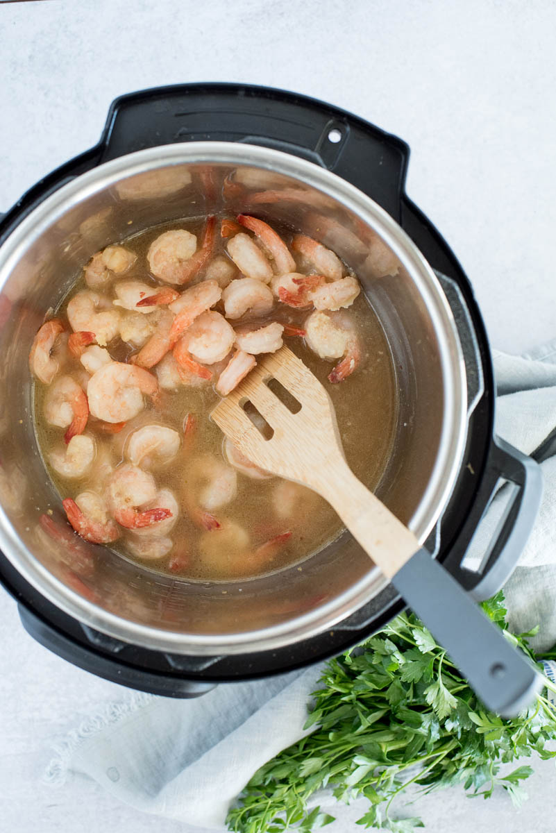 overhead of an instant pot cooking pink shrimp