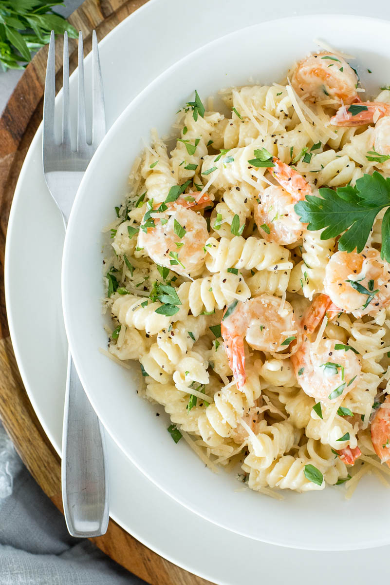 overehad of a white bowl with shrimp alfredo pasta