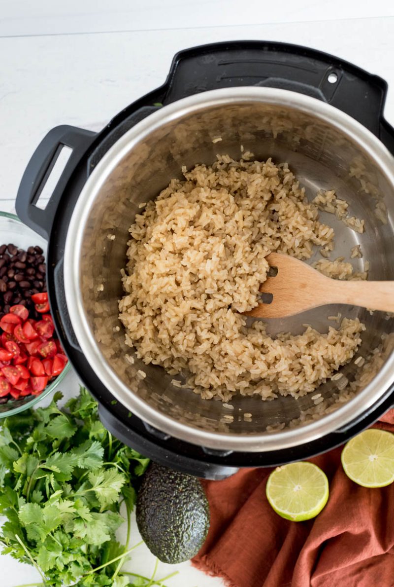 overhead of an instant pot cooking brown rice with beans on the side
