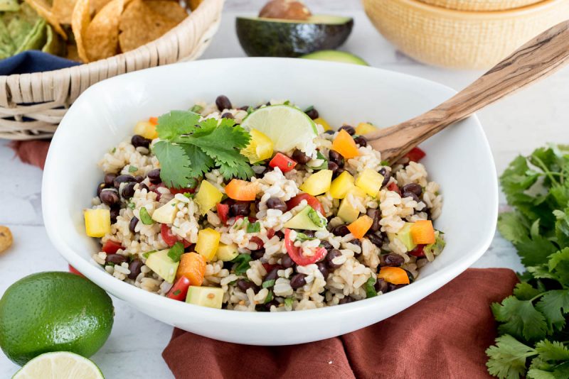 bowl of instant pot black bean and rice salad with limes