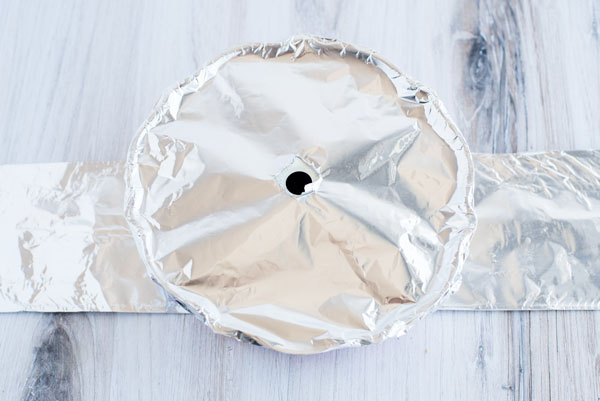 Aluminum foil covering the half-sized bundt pan with a foil sling for pot in pot Instant Pot cooking.