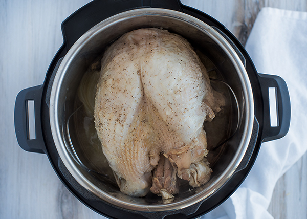 Cooked pressure cooker turkey breast inside an Instant Pot Duo.