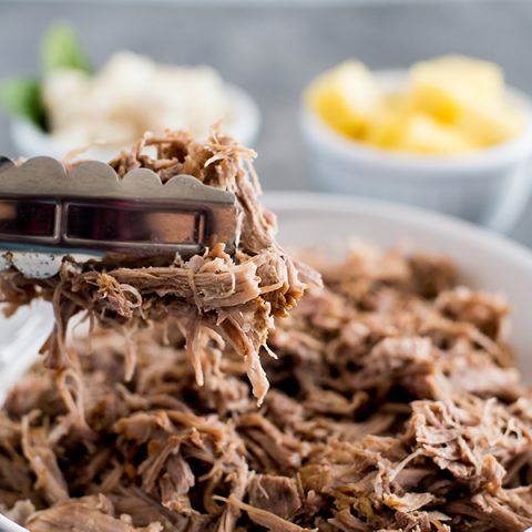 Instant Pot / Pressure Cooker Kalua Pork recipe, plated and ready to serve with pineapple and white rice