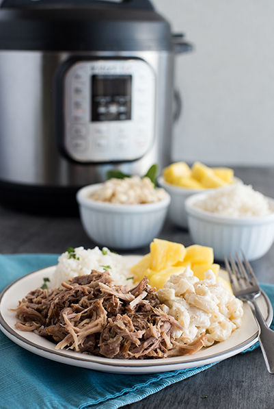 Instant Pot Kalua Pork recipe, plated and ready to serve with pineapple and macaroni and cheese and white riice