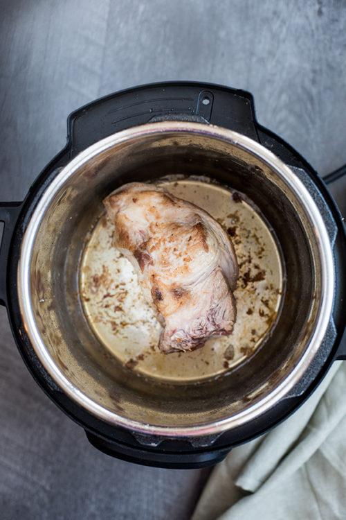 Instant Pot / Pressure Cooker Pulled Pork recipe, pork shoulder browning inside of the Instant Pot