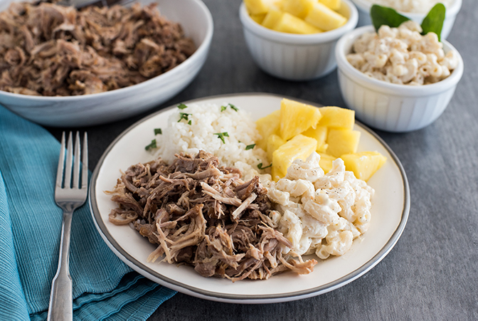 Insta Pot Kalua Pork recipe, plated and ready to serve with pineapple and macaroni and cheese