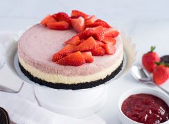 Strawberry Cheesecake with diced strawberries garnished on top.