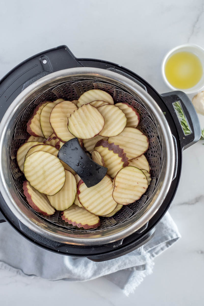an overhead shot of the cut potatoes in the pressure cooker