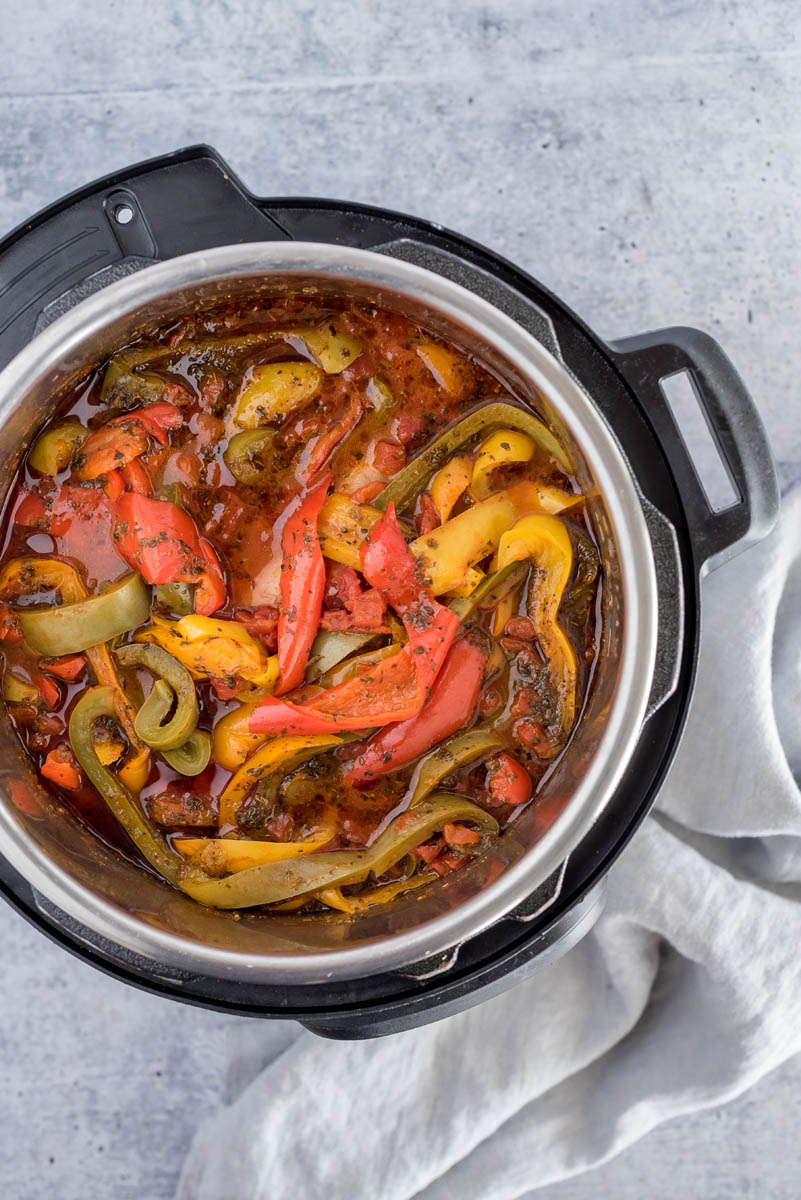 Overhead shot of sausage and peppers cooked inside an Instant Pot.