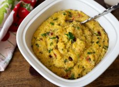 Pressure Cooker (Instant Pot) Sun-Dried Tomato Herbed Polenta in a white bowl with a spoon
