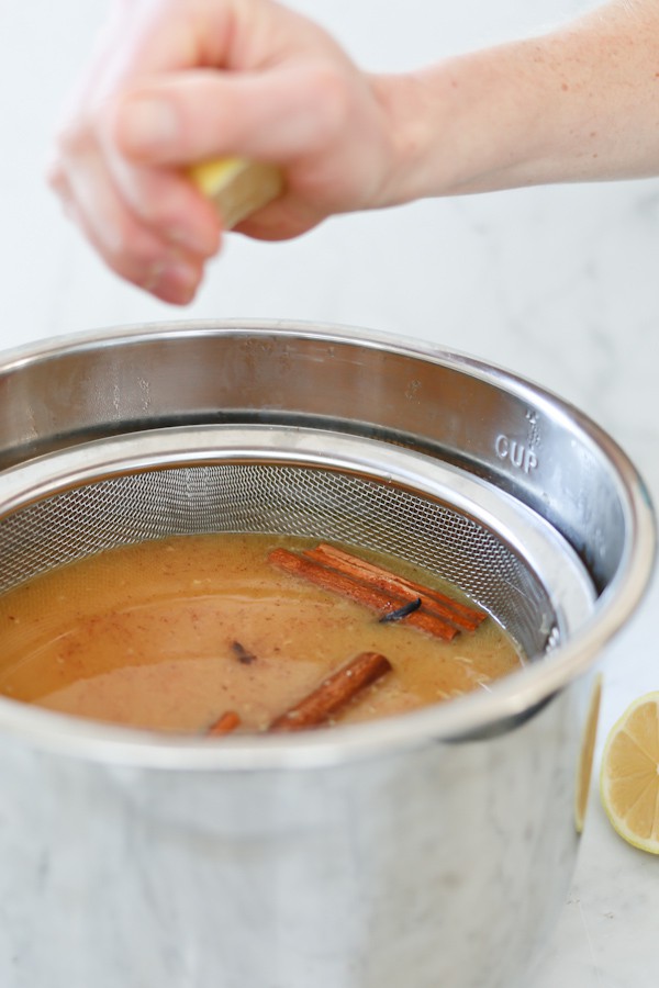 wassail that was made in an Instant Pot is strained to remove citrus pulp