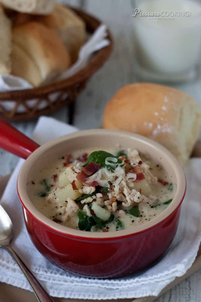 Pressure Cooker Zuppa Toscana served in a red bowl